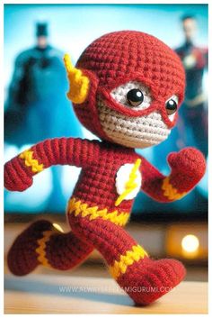 a crocheted stuffed toy with a flash on it's face and hands