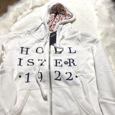 White Zip Up Hoodie By Hollister. Shop Now. Spring Streetwear Outerwear With Cozy Fit, Cozy Fit Spring Outerwear For Streetwear, Cozy Spring Streetwear Outerwear, Cozy White Hooded Jacket For Fall, Cozy White Hooded Jacket With Double-lined Hood, White Hoodie For Cold Weather In Fall, White Hoodie For Fall, Fitted White Hoodie For Winter, Casual White Hooded Winter Jacket