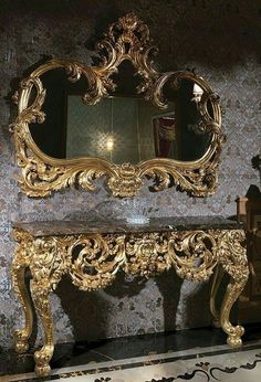 an ornately decorated table and mirror in a room