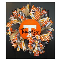 an orange and white wreath with the word tennessee on it