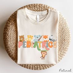 Pediatric Nurse Shirt Crewneck Gift With Animals, Pediatric Shirt, Peds Nurse Shirt Gift, Peds Nurse Crew Shirt, Pediatric Nursing Shirt ❥ DESCRIPTION: This pediatric nurse shirt crewneck gift with animals is unisex, soft, lightweight, with just enough stretch. 100% soft cotton and quality print make users fall in love with it over and over again. This adorable pediatric nurse shirt makes a great peds nurse gift or for anyone working in pediatrics. ❥ BRAND: Bella + Canvas Unisex Jersey T-Shirt (Crewneck) ❥ COLOR: Ash Grey, Black, Dark Heather Grey, Heather Mauve, Heather Peach, Natural, Pink, White ❥ SIZE CHARTS: See the image for sizing measurements. Fit is true to size. It's Unisex so if you prefer a slimmer fit, size down one size. If you prefer a looser fit, go up one size. To ensure t Cotton Crew Neck Shirt With Character Print, Cotton Graphic Tee With Character Print, Cotton Graphic Tee Shirt With Character Print, Playful Printed Cotton Shirt, Playful Cotton Shirt With Cartoon Print, Multicolor Cartoon Print Cotton Shirt, Multicolor Cotton Shirt With Cartoon Print, Funny Printed Cotton Shirt, Novelty Cotton T-shirt With Character Print