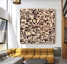 a living room filled with furniture and a large painting on the wall