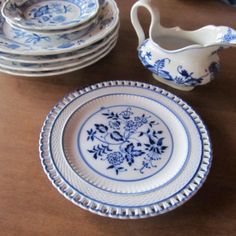 blue and white china on a wooden table