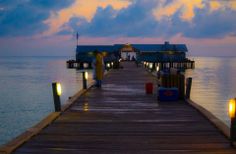 a pier with some lights on it in the water