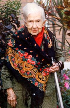 an old woman is holding a cane in her hand and has a quote on it