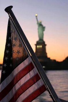 an american flag and the statue of liberty