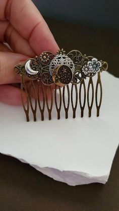 Celestial Hair comb  This Crescent Moon face Hair Comb makes a lovely hair accessory for beautiful hair styles. This haircomb is charming with elegant and amazing Flowers. It is great for special occasions like weddings, but can also be great for everyday wear ☻Link to More Hair Accessories: https://www.etsy.com/shop/FashionCrashJewelry?ref=profile_header&search_query=hair+accessories ☻Link to The ENTIRE SHOP: https://www.etsy.com/shop/FashionCrashJewelry?ref=shopsection_shophome_leftnav&ga_sear Celestial Hair Comb, Crescent Moon And Sun, Celestial Hair, Floral Hairpiece, Sun Hair, Hair Accessories Vintage, Pin Man, Man In The Moon, Vintage Hair Combs