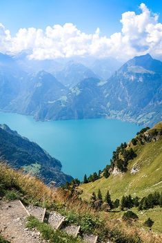 a bench on the side of a mountain overlooking a lake