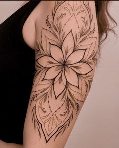 a woman's arm with a flower tattoo on the left side of her body