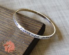 "This custom bangle bracelet is made of sterling silver (92.5%) and hand stamped with the names of your loved ones or the message of your choice. Price is per bangle, so order the quantity you need. What a great gift for a mother or grandmother in your life. Each bangle can be stamped with up to aprox. 75 characters (including spaces). Text is only stamped on one side. Each bracelet is made by hand, formed, hammered and polished to a high shine. These bangles are handcrafted in the size and quan Bracelet Names, Grandma Bracelet, Custom Bangle, Message Bracelet, Moms Bracelet, Rose Gold Heart, Brave Soul, Cross Bracelet, Name Bracelet