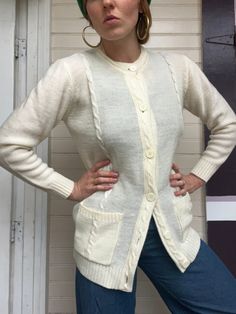 "70s cream cardigan up for grabs! Features a crewneck, six buttons down front, long sleeves, pocket at each hip, extra long fit. Lightweight + soft material, mid-thickness. No tag on garment, possibly handmade. Feels like acrylic/acrylic blend. Measurements: Size listed: none Fits like: women's medium/large  Shoulders: 34\" Bust: 41\" Waist: 35\" Hips: 38\" Sleeve length: 22.5\" Total length: 29\" Condition: Amazing vintage condition! No discrepancies with garment." White Cable Knit Button-up Outerwear, Cream Crew Neck Cardigan With Button Closure, Cream Crew Neck Outerwear For Layering, Vintage Long Sleeve Cardigan For Layering, Vintage Style Long Sleeve Cardigan For Layering, White Sweater With Pockets For Layering, Beige Crew Neck Sweater With Buttons, White Layering Sweater With Pockets, Classic White Sweater With Pockets