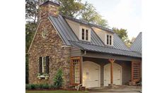 two story house with stone and metal roof