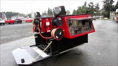 a red and black truck parked in a parking lot