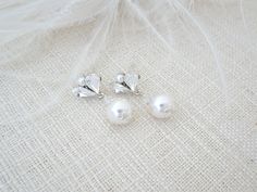 This simple and classic pearl bridal earring features Swarovski crystals and pearls.  A timeless design bringing a hint of sparkle to you or your bridesmaids. Earrings measure 1 inch in length. 8mm pearl drop The pearls have a soft natural white color which pair nicely with either white or light ivory gowns. Items arrive in a beautiful hand decorated gift box. Ready to ship in 3-5 business days. Pearl White Crystal Drop Earrings For Wedding, White Pearl Drop Crystal Earrings For Wedding, Elegant Silver Pearl Earrings For Bride, Classic Pearl Drop Crystal Earrings For Wedding, Elegant Pearl Drop Earrings For Bride, White Pearl Drop Earrings For Bride, Bride White Pearl Drop Earrings, Pearl White Earrings For Mother Of The Bride, Dainty Wedding Earrings