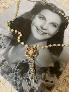 This is a handcrafted vintage assemblage necklace. I started with a vintage, faux pearl and amethyst colored brooch. I then added a vintage, mini fork. The necklace portion consists of faux pearl rosary beads. This is very simple yet Oh so unique and adorable definitely one-of-a-kind! And returns. Shipped to continental US only. Vintage Pearl Pendant Necklace With Pearl Charm, Vintage Pendant Necklace With Pearl Chain, Handmade Vintage Pearl Necklace For Gift, Handmade Victorian Pearl Necklaces, Vintage Pearl Jewelry With Vintage Charm, Handmade Victorian Pearl Necklace, Vintage Pearl Necklace For Vintage Events, Vintage Pearl Chain Necklace, Vintage Pearl Pendant Necklace