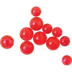 red candy balls are scattered on a white surface