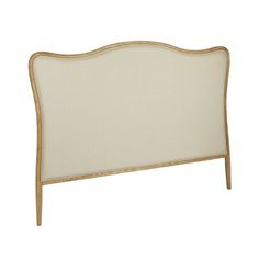 an upholstered headboard for a bed with white linen and gold trimmings