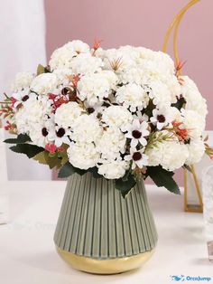 a vase filled with white flowers on top of a table