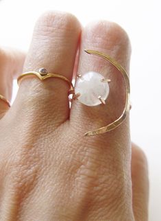 This beautiful white moonstone gemstone features a subtle glow. Set in 14k gold fill, this ring is a perfect for everyday wear or as a statement piece. Featuring a stunning crescent moon shape design. Ring is made in size 6 and is adjustable due to the style of the ring. It can be made larger upon request before purchase. Gemstone is approx. 10mm in diameter. This piece is a very limited edition. Please note: Due to the nature of the moonstones, each of these stones can vary from the original. M Adjustable Gold Moon-shaped Moonstone Ring, Adjustable Ethereal White Jewelry, Delicate Adjustable Moonstone Ring, White Adjustable Celestial Moonstone Ring, Adjustable Moon Shaped Elegant Crystal Ring, Adjustable Crescent Moonstone Ring, Adjustable Moon-shaped Elegant Crystal Ring, Adjustable Elegant Moon Shaped Crystal Ring, Minimalist Moonstone Moon-shaped Ring