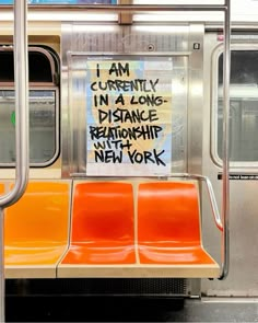 a sign on the back of a subway car that says i am currently in a long distance relationship with new york