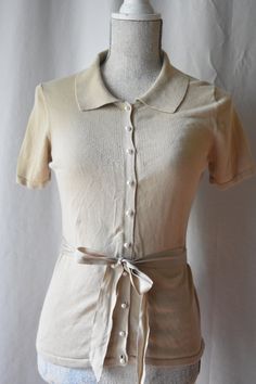 "Sophisticated and feminine, vintage, beige button up collared sweater blouse with lovely pearl buttons. With short sleeves and a nice matching sash to tie around the waist. There is some stretch to the fabric. Women's size S. Bust: 34\" Waist: 30\" Length: 23: Tag: East 5th Material: 57% cotton 43% rayon" Collared Sweater, Shirt Business, Pop Style, Casual Attire, Collar Blouse, Pearl Buttons, Sweater Blouse, Womens Clothing Tops, Sweater Shirt