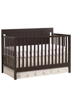 a baby crib with white and brown sheets