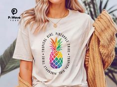 This fun and colorful t-shirt is sure to turn heads. The rainbow pineapple design is perfect for anyone who loves tropical vibes and spreading positivity. Made from high-quality materials, this t-shirt is soft, comfortable, and stylish. Crafted from premium 100% cotton jersey knit (4.2 oz), this ultra-soft unisex tee ensures all-day comfort and breathability. The vibrant colors and distinctive pop art aesthetic make it a truly statement-making piece. Key Features: * Rainbow pineapple design * Comfortable fit * Stylish design * Perfect for summer * Great for everyday wear * Lightweight and luxuriously soft fabric * Eco-friendly, ethically produced * Designed for a relaxed retail fit Sizing: * S:       Width: 18" (46 cm)   Length: 28" (71 cm) * M:      Width: 20" (51 cm)   Length: 29" (74 cm Summer Rainbow Print Crew Neck T-shirt, Colorful Rainbow Print Summer T-shirt, Pineapple Shirts For Women, Tie Dye Rainbow Print T-shirt For Summer, Tropical Multicolor Graphic T-shirt, Tropical Multicolor Graphic Print T-shirt, Pineapple Shirt, Pineapple Design, Tropical Vibes