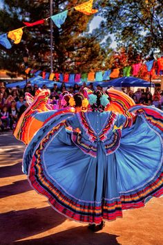 a group of people that are standing around with some kind of colorful dress on them