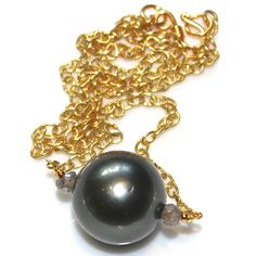 "This amazing natural green Tahitian pearl necklace will be a fast favorite. A gorgeous naturally colored large gem quality Tahitian pearl is accented with shimmery labradorite on a gold vermeil chain. This necklace measures approximately 16\". Sublime!! xoxoxo payton For more cool jewelry looks, check out http://www.etsy.com/shop/FizzCandy All FizzCandy creations come beautifully boxed and ready for gift giving. Please see our store policies here - https://www.etsy.com/shop/FizzCandy/policy?ref Gift Tahitian Pearl Necklace With High Luster, Tahitian Pearl Drop Necklace As Gift, High Luster Tahitian Pearl Necklace As Gift, Tahitian Pearl Drop Necklace For Gift, High Luster Tahitian Pearl Necklace, Tahitian Pearl Charm Necklace With Round Pendant, Tahitian Pearl Jewelry With High Luster Beads, Tahitian Pearl Necklace With Round Pendant And Pearl Charm, Tahitian Pearl Round Pendant Necklace For Gift