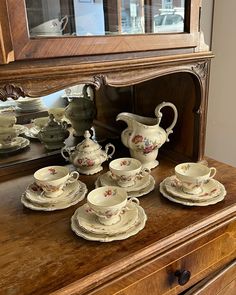 an old dresser with china on it