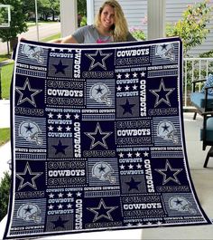 a woman holding up a blanket with cowboys on it