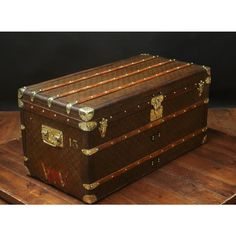 an old trunk sitting on top of a wooden table