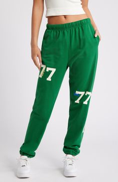 Number graphics lend varsity style to lounge-ready sweatpants cut from a breathable cotton blend. 32" inseam; 12" leg opening; 13" front rise; 16" back rise (size Large/X-Large) Elastic waist Side-seam pockets Elastic cuffs 84% cotton, 16% polyester Machine wash, line dry Imported Green Bottoms With Letter Print For Streetwear, Green Cotton Activewear For Jogging, Casual Green Bottoms For Sports Season, Green Cotton Activewear For Exercise, Cotton Sweatpants For Sports Season Loungewear, Green Sporty Sweatpants With Letter Print, Sporty Green Sweatpants With Letter Print, Cotton Sweatpants For Loungewear During Sports Season, Cotton Joggers For Loungewear During Sports Season