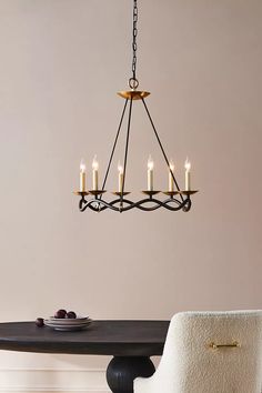 a chandelier hanging over a dining room table