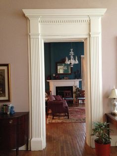 a living room filled with furniture and a fire place in the middle of a room