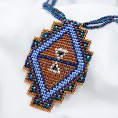 Trendy and tribal-inspired, the Mayan Pyramid Beaded Pendant Necklace makes a bold statement. Perfect for pairing with whites or denim for a great boho look. Made by women artisans of La Casa in Guatemala. Since 2000, La Casa Cotzal has designed a range of Guatemalan handcrafted pieces produced by artisan communities throughout the country. Mayan women traditionally have been backstrap loom weavers, but increasingly they are learning to use pedal looms as well. In traditional Guatemalan weaving, the two main specialized techniques are ikat and supplementary weft brocade. Artisans at La Casa are versed in both weaving techniques as well as in intricate bead work. The work provided by La Casa is vital to the women's families and communities. Glass beads & cotton thread Pendant: 3.25" H x 2" Guatemalan Weaving, Mayan Women, Paw Print Jewelry, Spirit Clothing, Backstrap Loom, Fair Trade Clothing, Ribbon Jewelry, Fair Trade Jewelry, Printed Jewelry