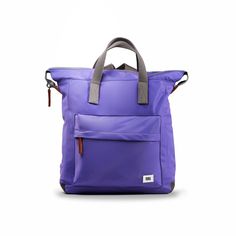 a purple tote bag sitting on top of a white surface