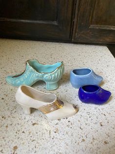 three pairs of shoes sitting on top of a counter