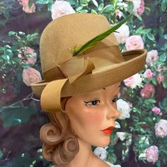 Vintage 1960's hat by The Paris Boutique has a camel wool body. Hat has a grograin ribbon band with two green feathers. Size Large. Excellent condition. Please see photos for more details. All items are vintage that are preowned. All of the items may show some form of wear due to their age. Please kindly remember that these items are anywhere from 30-80 years old. I make every attempt to clearly describe the item, including any flaws or wear to the best of my ability. Returns are not accepted based on the condition of the item. I urge you to the please contact me with any and all questions. I am happy to provide more photos of the item on request. Vintage Beige Felt Hat For Winter, Vintage Cream Hat Bands With Flat Brim, Retro Beige Short Brim Hat, Vintage Cream Fitted Fedora, Vintage Beige Fedora Felt Hat, Vintage Cream Brimmed Felt Hat, Vintage Fitted Cream Fedora, Vintage Beige Top Hat With Curved Brim, Fitted Vintage Cream Fedora