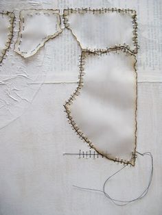 the fabric is being stitched together to make a piece of art that looks like a map