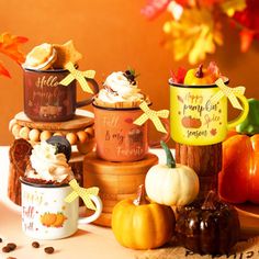 a table topped with lots of different types of cupcakes and coffee mugs