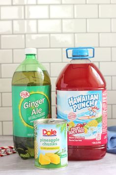 the ingredients to make pineapple punch are displayed on a counter top, including juice and water