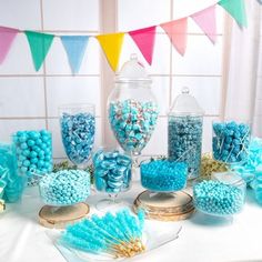 a table topped with lots of blue and white candy