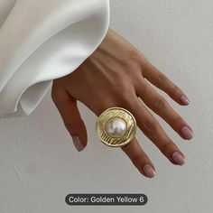 Elevate Your Style With This Stunning Gold-Plated Ring. The Bold Statement Piece Features A Round Shape And A Band Style That Exudes Elegance And Sophistication. The White Main Stone Color Adds A Touch Of Glamour To The Overall Design, Making It Perfect For Any Occasion. Crafted With High-Quality Zinc Alloy, This Ring Is Durable And Long-Lasting. It Is Available In Os Ring Size, Making It An Ideal Fit For Many. Perfect For Fashion-Forward Women, This Ring Is A Must-Have Accessory In Your Jewelry Pearl Statement Ring, Plated Ring, Gold Plated Rings, Womens Jewelry Rings, Round Shape, Zinc Alloy, Stone Color, The White, Statement Rings