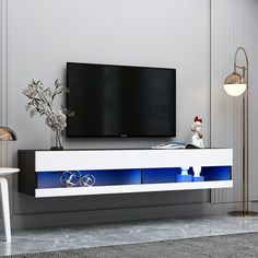 a television is mounted on the wall in a room with white walls and flooring