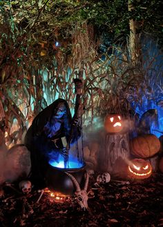 a man dressed up as jack - o'- lantern in front of pumpkins