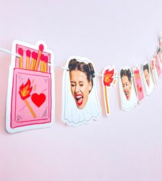 a pink and red banner with photos of women hanging from it