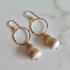 Hawaiian Shell Hoops ~ Beautiful Hawaiian cone shells drop from 14k gold fill textured hoops, fun beach inspired jewelry. Hoops approx. 1" Shells .75" Shop~ http://www.etsy.com/shop/HanaMauiCreations?ref=pr_shop_more International buyers please read our shipping policies before ordering~ POLICIES~ https://www.etsy.com/shop/HanaMauiCreations/policy?ref=shopinfo_policies_leftnav Gold Small Hoop Jewelry For The Beach, Gold Hoop Jewelry For Beach, Summer Beach Gold Hoop Earrings, Gold Teardrop Hoop Earrings For Summer, Gold Hoop Earrings For Summer Beach, Gold Small Hoop Earrings For The Beach, Bohemian 14k Gold Filled Jewelry For Beach, Handmade Gold Hoop Earrings For Beach, Handmade Small Hoop Earrings For Vacation