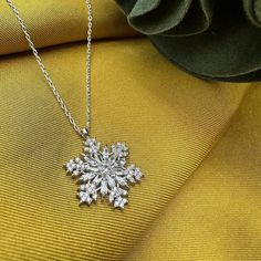 This magnificent necklace combines elegance and elegance. Handmade and carefully designed, this snowflake necklace will make you different on special occasions or in your daily life. It can be a unique gift idea. With its quality silver material and elegant design, this jewelry will make your loved ones very happy. Meaning of Snowflake Silver Necklace: It is to secretly and silently indicate that the person to whom the gift is given will be your one and only. Because every snowflake is unique, different and special. A thin silver necklace combined with a delicate chain will elegantly highlight your neck. - There are silver and gold color options. Features: - 925 sterling silver material -Chain Length: 45 cm - Snowflake: 2 cm - Handmade and special design - Since the product is entirely sil Sterling Silver Necklaces For Winter Gifts, Christmas Silver Cubic Zirconia Necklace, Silver Snowflake Necklace With Cubic Zirconia, Silver Cubic Zirconia Necklaces For Christmas, Silver Cubic Zirconia Snowflake Necklace, Elegant Winter Jewelry As Gift, Silver Snowflake Necklace For Gift, Silver Snowflake Necklace For Holiday, Snowflake Jewelry For Holiday Gifts