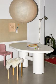 a white table and two chairs in a room